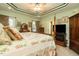 Cozy main bedroom with a trey ceiling, a four-poster bed, fireplace, and plenty of natural light at 229 Hocutt Farm Dr, Clayton, NC 27527