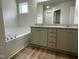 Bathroom featuring a tub and double sink with granite countertops at 265 Eason Creek Way, Clayton, NC 27527