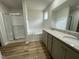 Bright bathroom featuring a shower, tub, and double sink with granite countertops at 265 Eason Creek Way, Clayton, NC 27527