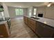 Kitchen featuring a stainless steel dishwasher, granite countertops, and hardwood floors at 265 Eason Creek Way, Clayton, NC 27527