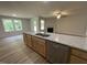 Kitchen featuring a stainless steel dishwasher, granite countertops, and hardwood floors at 265 Eason Creek Way, Clayton, NC 27527