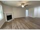 Spacious living room featuring hardwood floors, a ceiling fan, and a fireplace at 265 Eason Creek Way, Clayton, NC 27527
