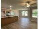 Open-concept living room featuring natural light, wood flooring and a ceiling fan at 265 Eason Creek Way, Clayton, NC 27527