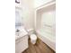 Bathroom featuring a shower and tub combination, a mirror, and modern fixtures at 27 Stonewall Way, Durham, NC 27704