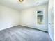 This bedroom features carpeted flooring, a window for natural light, and neutral walls at 27 Stonewall Way, Durham, NC 27704