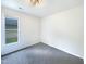 Bright bedroom featuring neutral walls, a window for natural light, and soft carpeting at 27 Stonewall Way, Durham, NC 27704