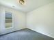 Bright bedroom features a window and neutral carpet at 27 Stonewall Way, Durham, NC 27704