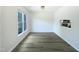 Dining room with hardwood floors, a bright window, and a pass-through counter at 27 Stonewall Way, Durham, NC 27704