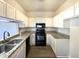 Clean kitchen features granite counters, white cabinets, and stainless appliances at 27 Stonewall Way, Durham, NC 27704