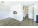 Open-concept living area featuring grey flooring, a fireplace, and a clear view of the kitchen at 27 Stonewall Way, Durham, NC 27704
