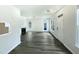 Open living room area with hardwood floors, fireplace, and windows at 27 Stonewall Way, Durham, NC 27704