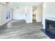 Open-concept living area featuring grey flooring, a fireplace, and a clear view of the kitchen at 27 Stonewall Way, Durham, NC 27704