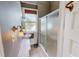 Traditional-style bathroom featuring a shower with glass doors, a sink, and grey walls at 29 Oak St, Roxboro, NC 27573