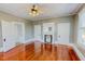 Bedroom showcasing hardwood floors, a fireplace, and white trim throughout the room at 29 Oak St, Roxboro, NC 27573