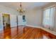 Bright dining room features hardwood floors, chandelier, and multiple entryways for entertaining at 29 Oak St, Roxboro, NC 27573