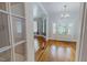 Entryway featuring hardwood floors, colorful doors, transom windows, and white trim at 29 Oak St, Roxboro, NC 27573