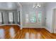 Inviting entryway with decorative stained glass door, chandelier, and access to adjacent living spaces at 29 Oak St, Roxboro, NC 27573