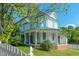 Charming two-story home boasts a wrap-around porch with stately columns and a metal roof at 29 Oak St, Roxboro, NC 27573