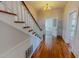 Inviting hallway with hardwood floors and a staircase leading to the upper level at 29 Oak St, Roxboro, NC 27573