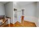 Hallway with wood flooring and a view into the bathroom at 29 Oak St, Roxboro, NC 27573