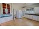 Functional kitchen with white cabinetry, updated appliances, and ample counter space at 29 Oak St, Roxboro, NC 27573