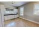 The kitchen features white appliances, laminate countertop, and natural light from the window at 29 Oak St, Roxboro, NC 27573