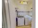 Laundry room featuring a washer, dryer, shelving, and white-painted wood paneled walls at 29 Oak St, Roxboro, NC 27573