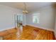 Bright living room featuring hardwood floors, chandelier lighting, and ample natural light at 29 Oak St, Roxboro, NC 27573