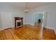 Spacious living room with a decorative fireplace, hardwood floors, and classic chandelier lighting at 29 Oak St, Roxboro, NC 27573