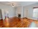 Living room featuring hardwood floors, a fireplace, and natural light at 29 Oak St, Roxboro, NC 27573