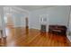Bright living room with hardwood floors, fireplace, piano, and seamless flow into adjacent rooms at 29 Oak St, Roxboro, NC 27573