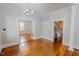 Spacious living room featuring hardwood floors, chandelier lighting, and elegant entryways at 29 Oak St, Roxboro, NC 27573