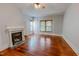 Living room features hardwood floors, a ceiling fan, and a fireplace at 29 Oak St, Roxboro, NC 27573