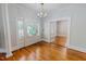 Spacious living room featuring hardwood floors, chandelier lighting, and fireplace at 29 Oak St, Roxboro, NC 27573