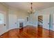 Bright living room featuring hardwood floors, fireplace, and staircase view at 29 Oak St, Roxboro, NC 27573