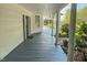 Charming porch with painted floor, white pillars, beadboard ceiling, and front door at 29 Oak St, Roxboro, NC 27573