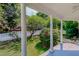 Relaxing covered porch offers an outdoor seating area, ceiling fan, and views of the yard at 29 Oak St, Roxboro, NC 27573