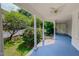 Relaxing covered porch offers an outdoor seating area, ceiling fan, and views of the yard at 29 Oak St, Roxboro, NC 27573