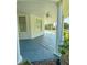 Charming porch with painted floor, white pillars, beadboard ceiling, and ceiling fan at 29 Oak St, Roxboro, NC 27573