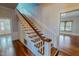 A classic wooden staircase with white banisters and beautiful hardwood floors at 29 Oak St, Roxboro, NC 27573