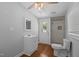 Bathroom with modern fixtures, glass enclosed shower, white vanity, and wood-look flooring at 301 Williamson St, Burlington, NC 27215