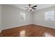 Bright bedroom featuring hardwood floors, a ceiling fan and a window for natural light at 301 Williamson St, Burlington, NC 27215