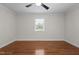Bright bedroom featuring hardwood floors, a ceiling fan and a window for natural light at 301 Williamson St, Burlington, NC 27215