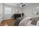 Bedroom with a ceiling fan, hardwood floors, and a console table at 301 Williamson St, Burlington, NC 27215