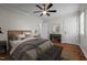 Staged bedroom with hardwood floors, a console table and a ceiling fan at 301 Williamson St, Burlington, NC 27215