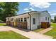 Ranch home featuring a decorative stone facade, bright yellow doors, and corner lot at 301 Williamson St, Burlington, NC 27215