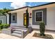 Charming home featuring a bright yellow door, gray accents, and professional landscaping for great curb appeal at 301 Williamson St, Burlington, NC 27215
