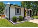 Charming home featuring a bright yellow door, gray accents, and professional landscaping for great curb appeal at 301 Williamson St, Burlington, NC 27215