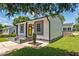 Charming home featuring a bright yellow door, gray accents, and professional landscaping at 301 Williamson St, Burlington, NC 27215