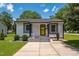 Charming home featuring a bright yellow door, gray accents, and professional landscaping for great curb appeal at 301 Williamson St, Burlington, NC 27215